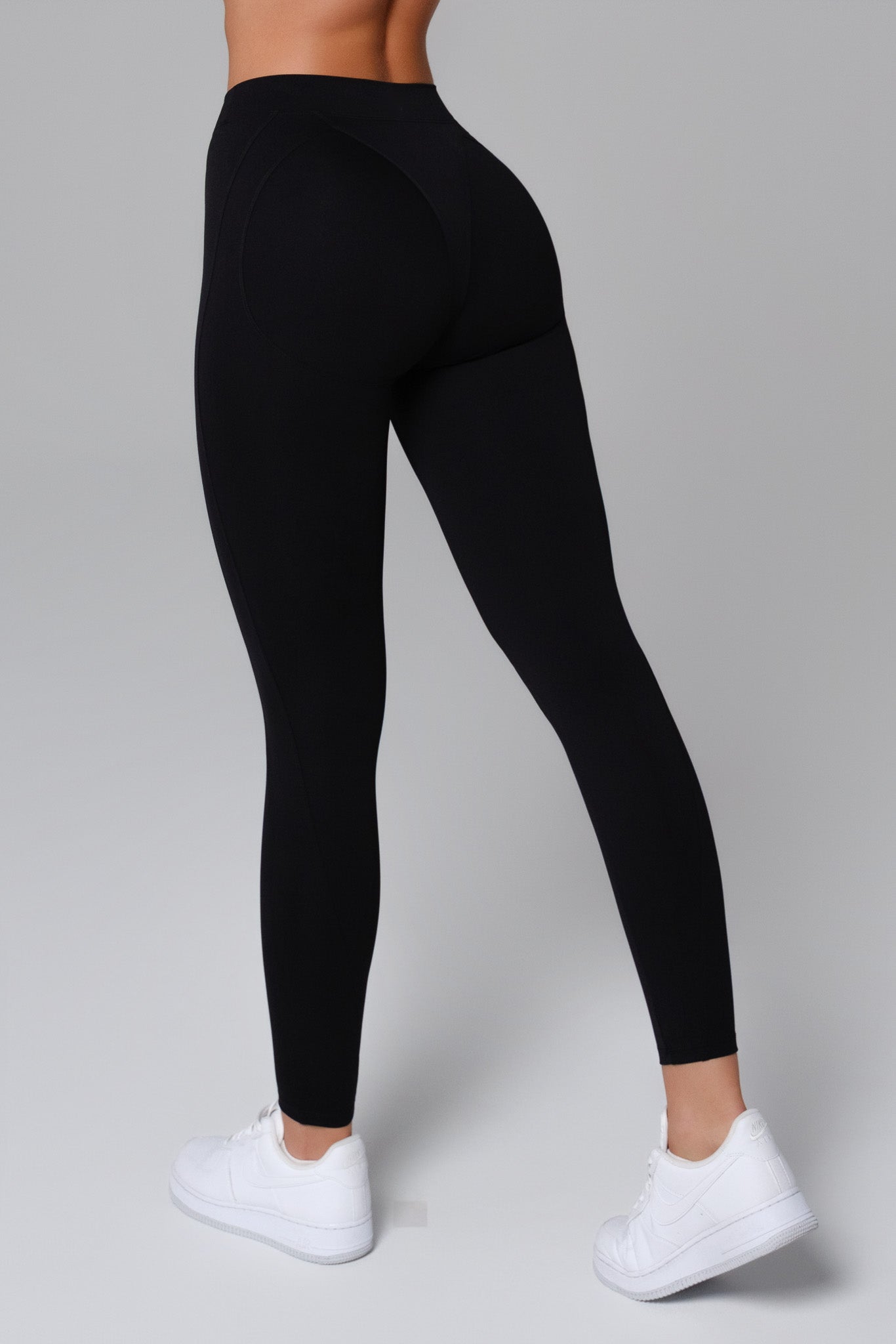 Black Maison and Aurora Essential High Waist Sculpting Leggings laid flat, showing the stretchy, form-fitting design and sleek waistband.