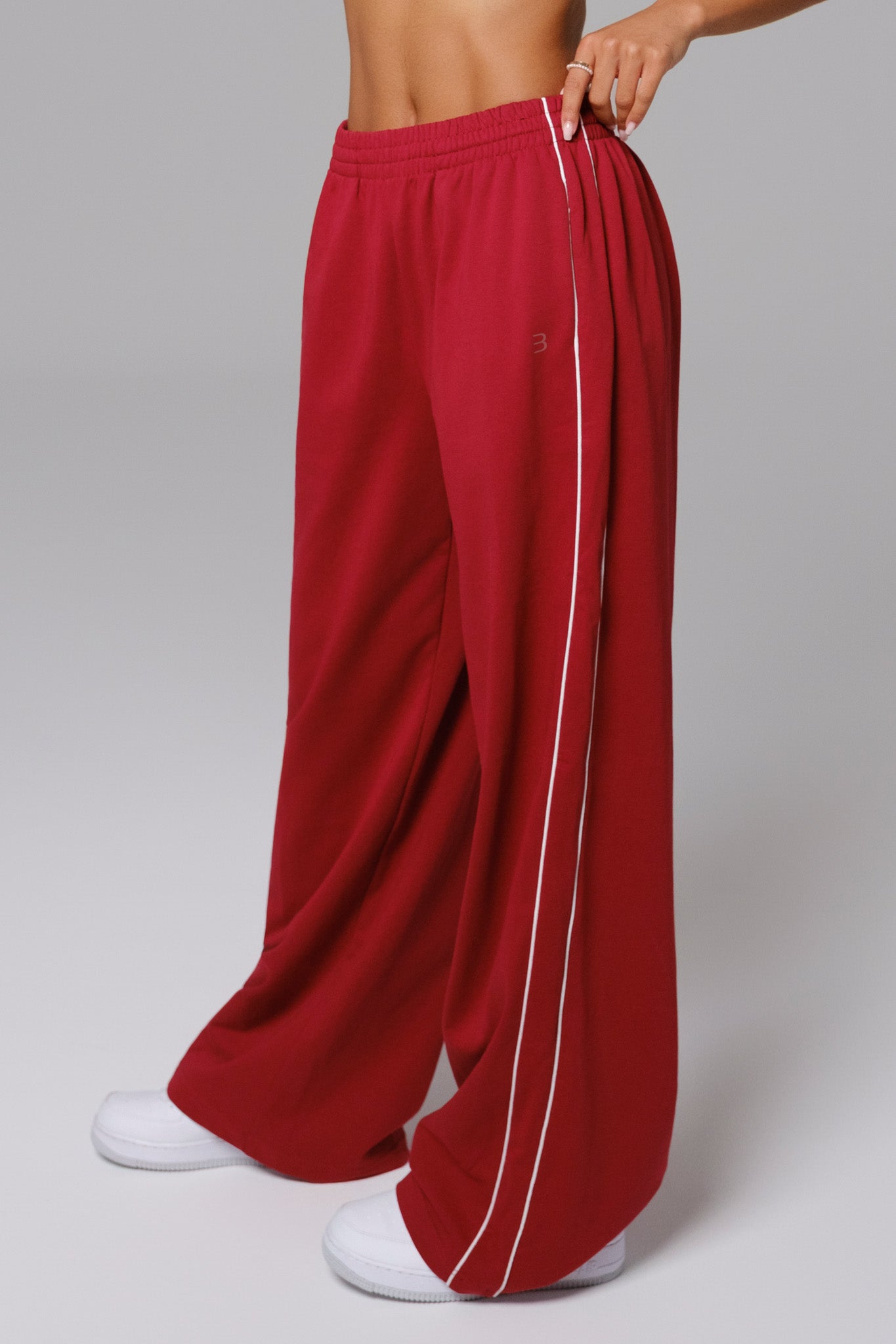 Maison and Aurora Shelly Sweatpants in cherry red, showing the comfortable fit and soft fabric with elastic waistband.