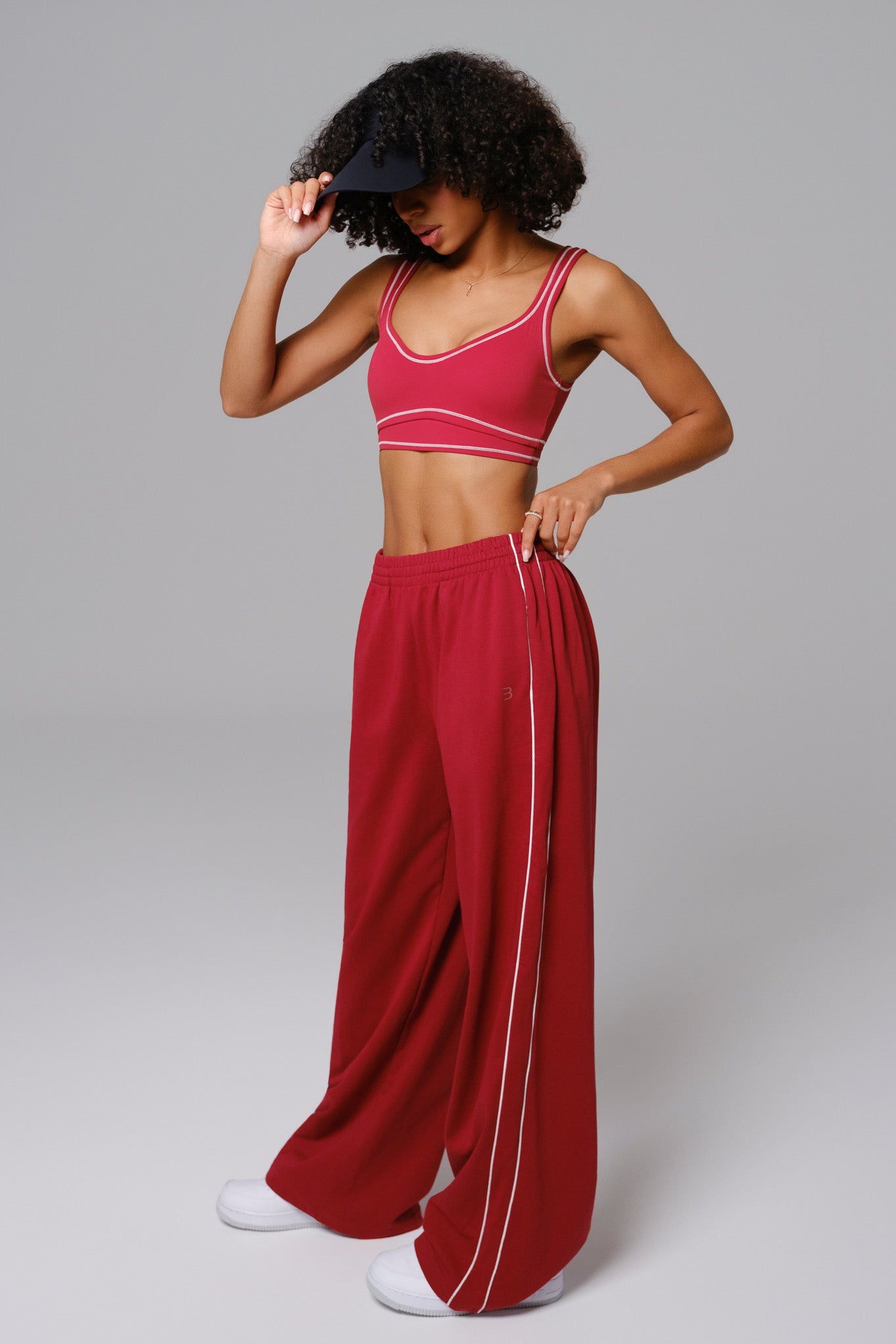 Maison and Aurora Shelly Sweatpants in cherry red, showing a close-up of the soft, comfortable fabric with relaxed fit and elastic waistband.