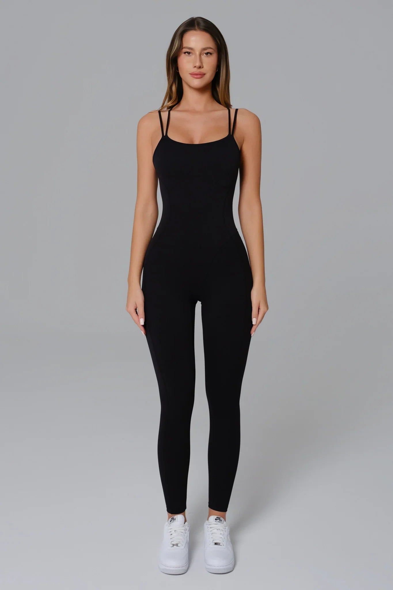 Black Maison and Aurora open-back jumpsuit, stylish and fitted, featuring a sleek design perfect for elegant occasions.