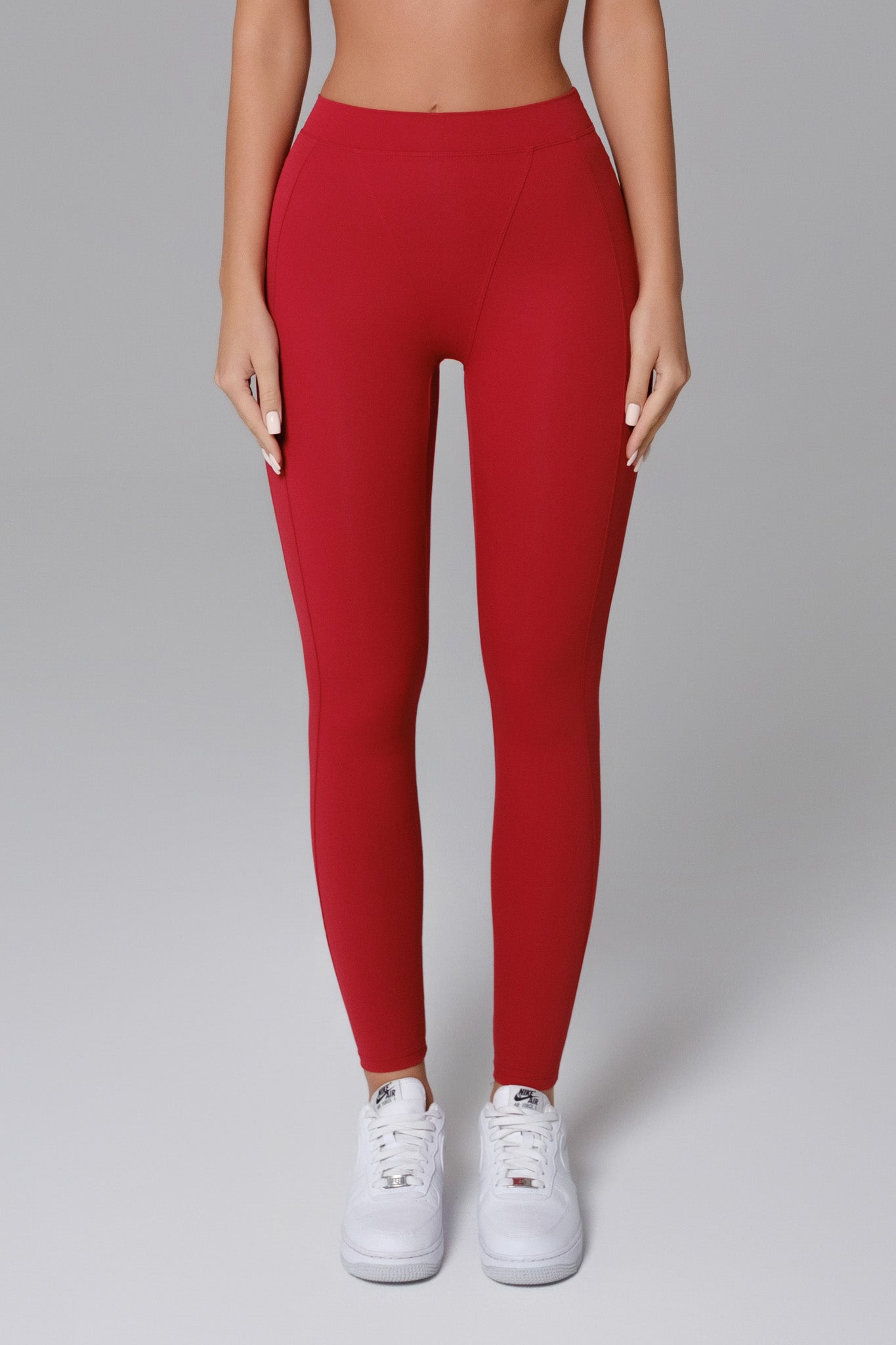 Maison and Aurora Essential High Waist Sculpting Leggings in Ember Red, showing the snug fit and high waist design.