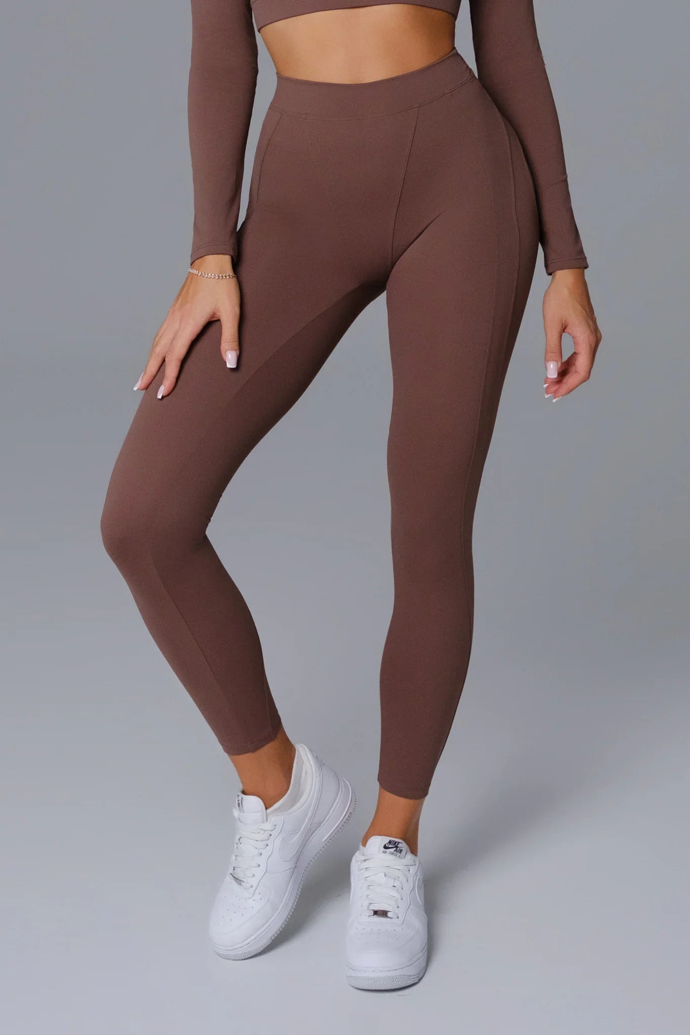 Maison and Aurora Essential High Waist Sculpting Leggings in Umber, showcasing the fitted, high-rise design and sculpting fabric.