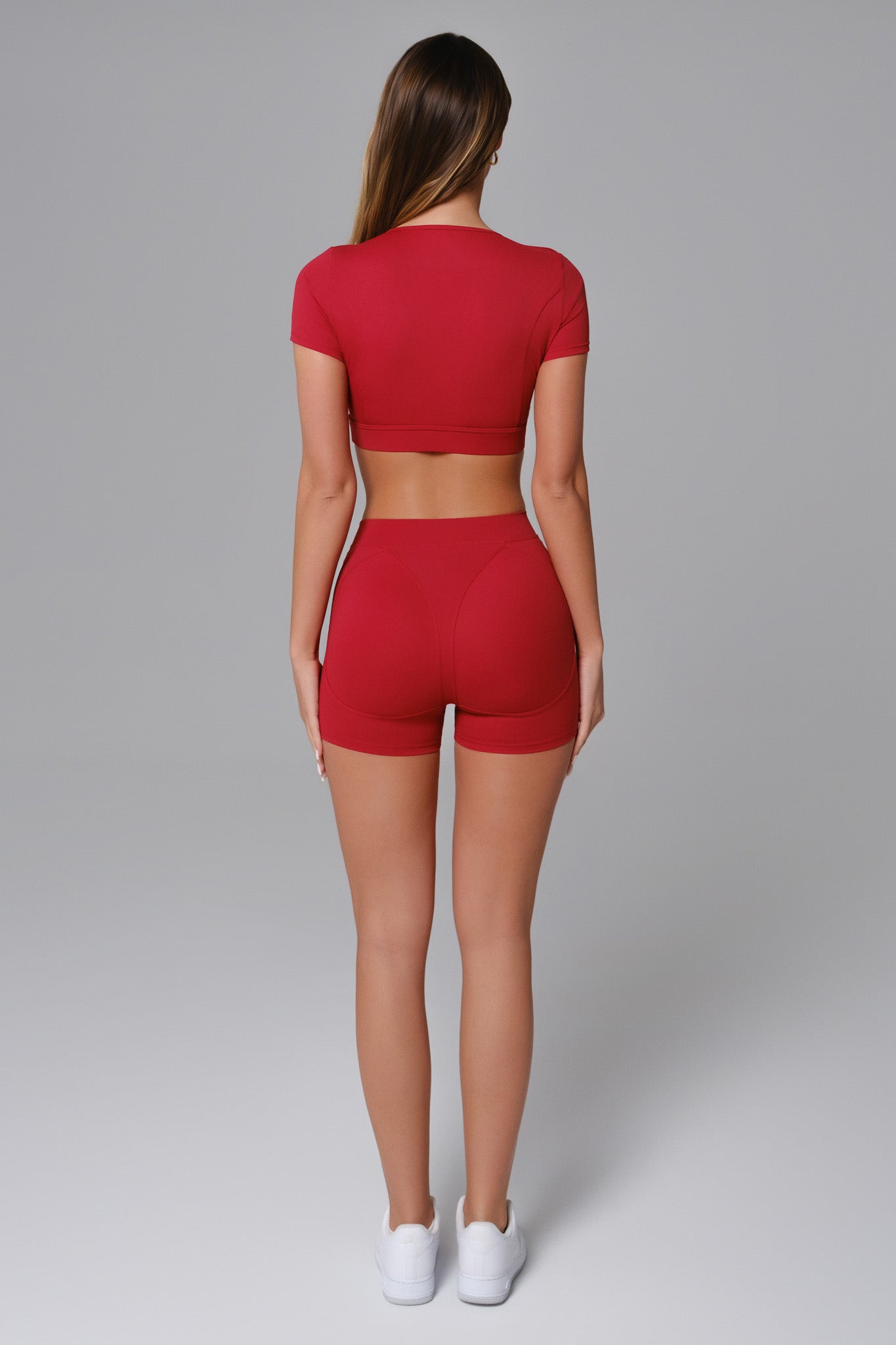 Maison and Aurora Ember Red High Waist Seamless Scrunch Shorts shown on model, highlighting their fitted, stretchy design and vibrant color.