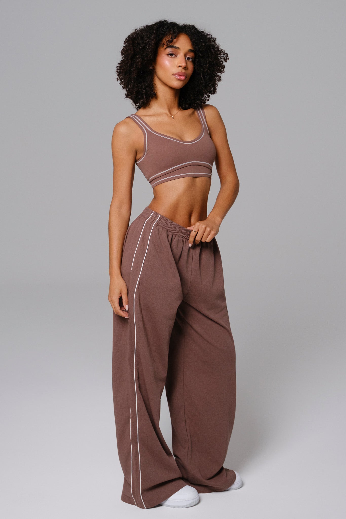 Maison and Aurora Shelly Sweatpants in soft chestnut, featuring a cozy fit and casual style, shown in a relaxed pose.