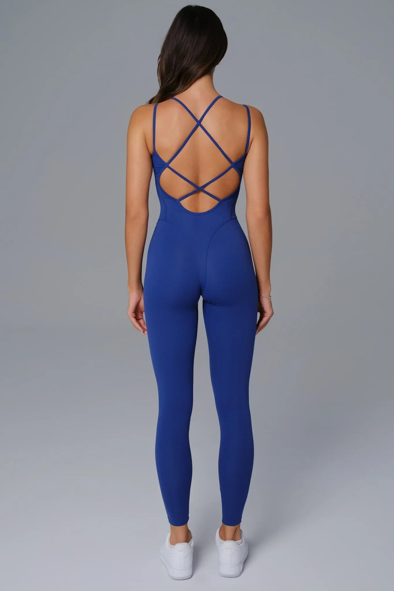 Maison and Aurora sapphire blue open-back jumpsuit, stylish and elegant, featuring a fitted waist and flowing wide-leg trousers.