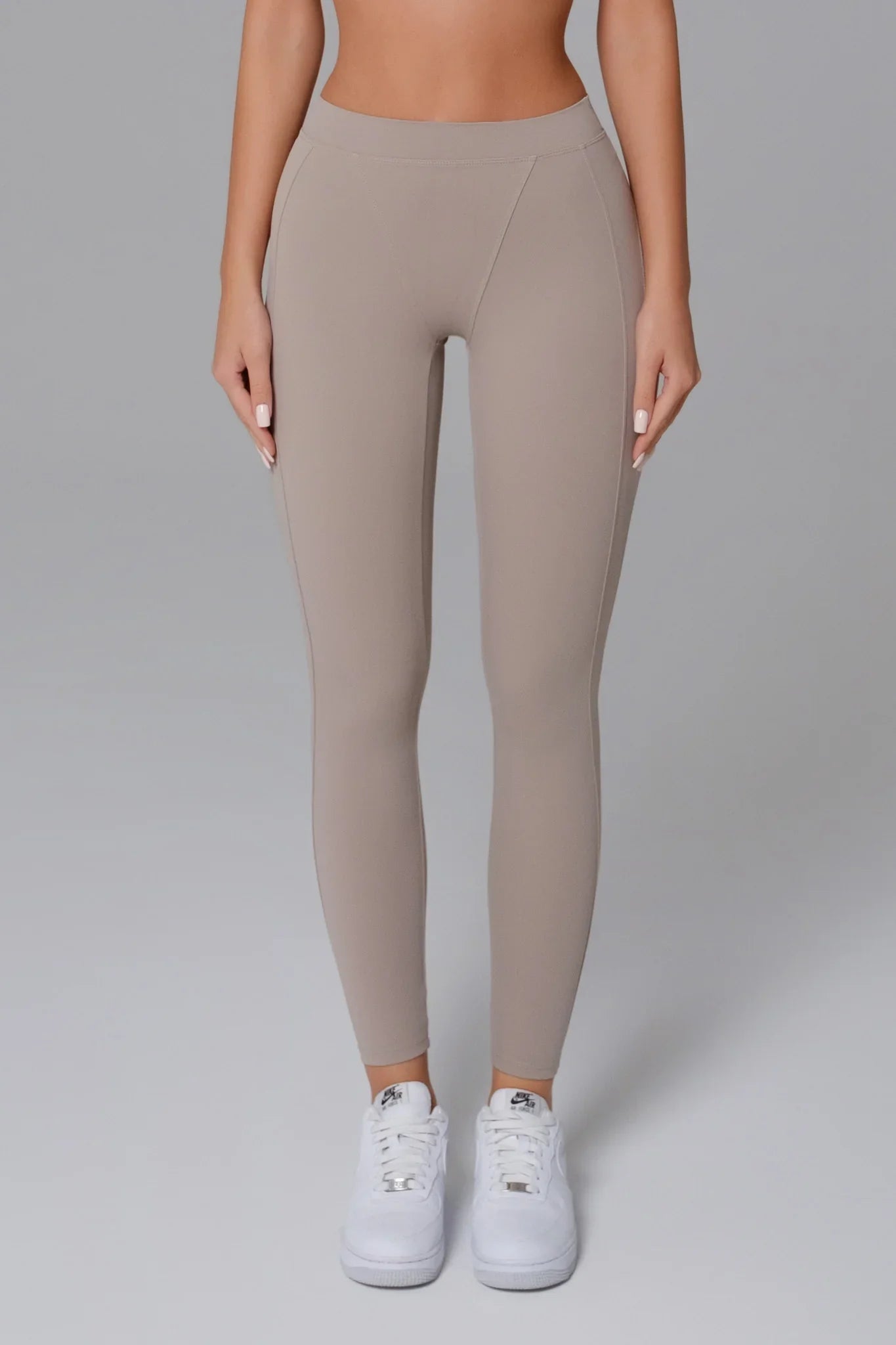 Maison and Aurora high waist sculpting leggings in greige, showcasing a close-up of the fitted, stretchy fabric and sleek design.