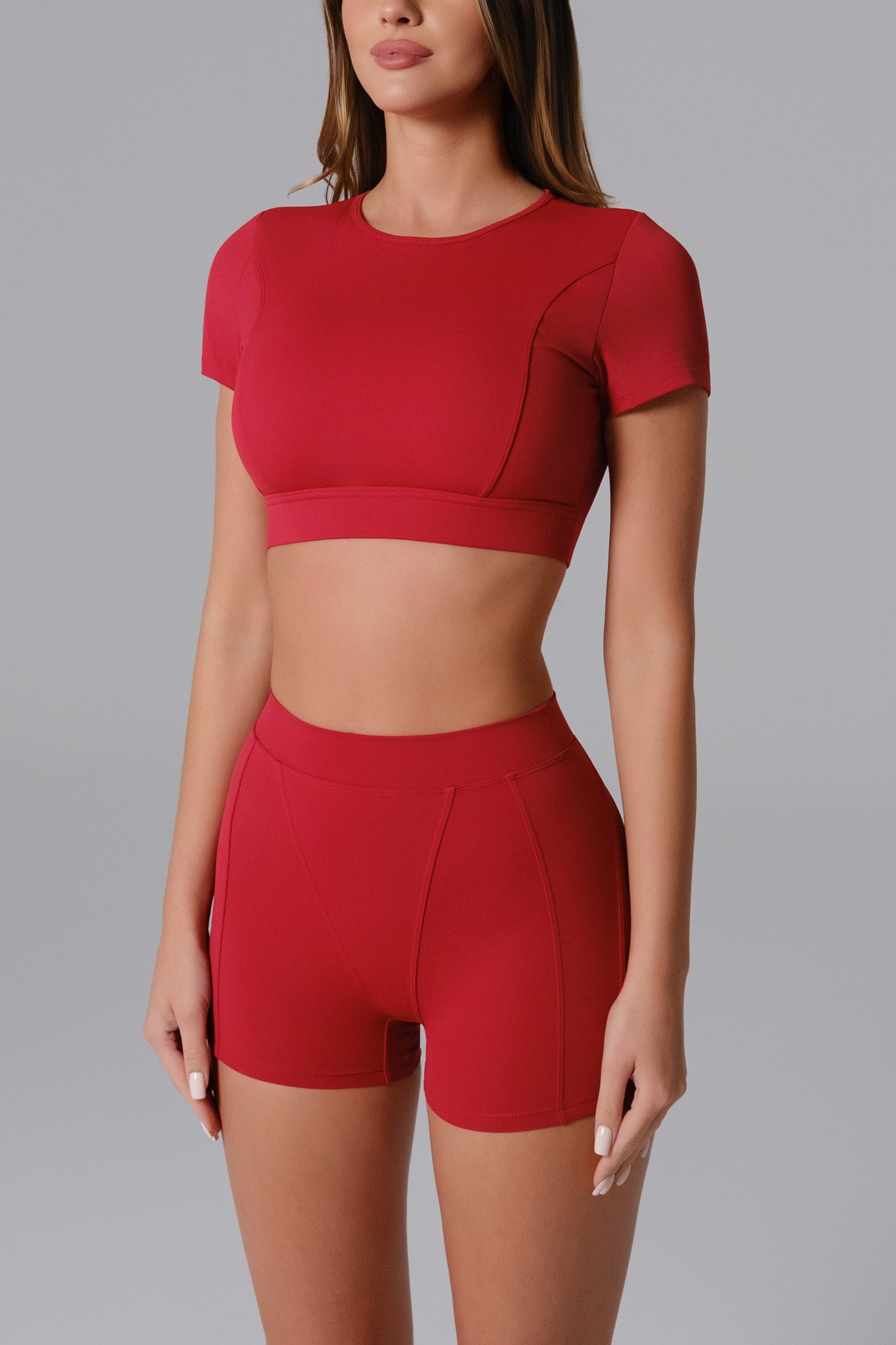 Maison and Aurora Ember Red high waist seamless scrunch shorts, showcasing their fit and vibrant color.