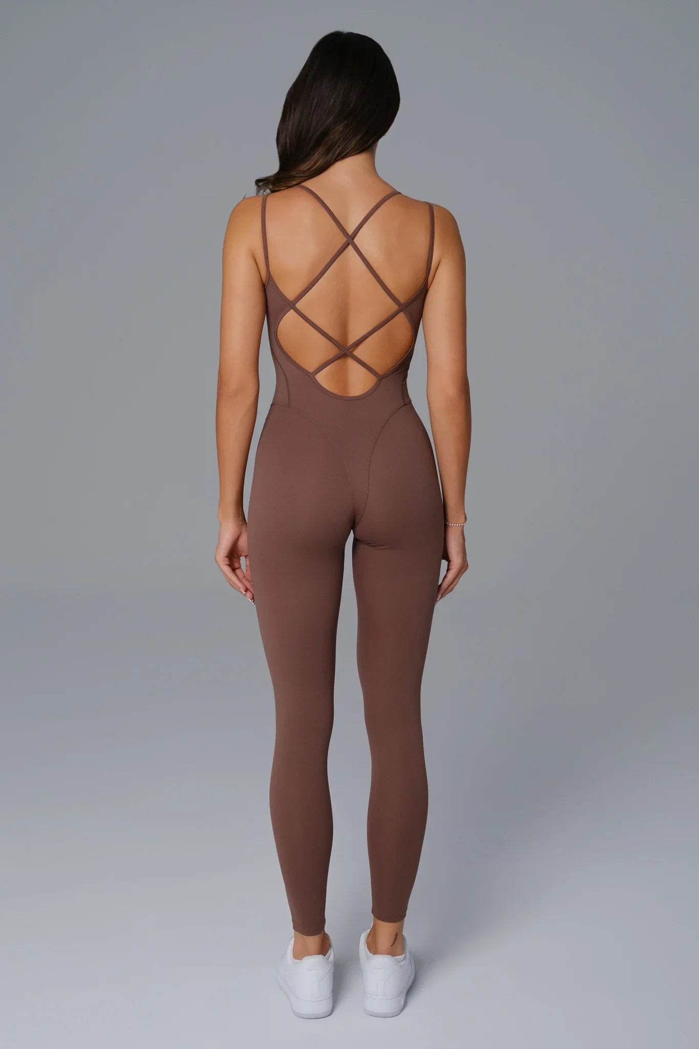 Maison and Aurora beige open-back jumpsuit with wide legs and sleeveless design, stylish and suitable for casual or evening wear.